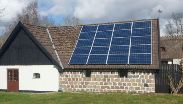 Residential house with roof-mounted solar panels connected to the utility grid
