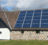 Residential house with roof-mounted solar panels connected to the utility grid