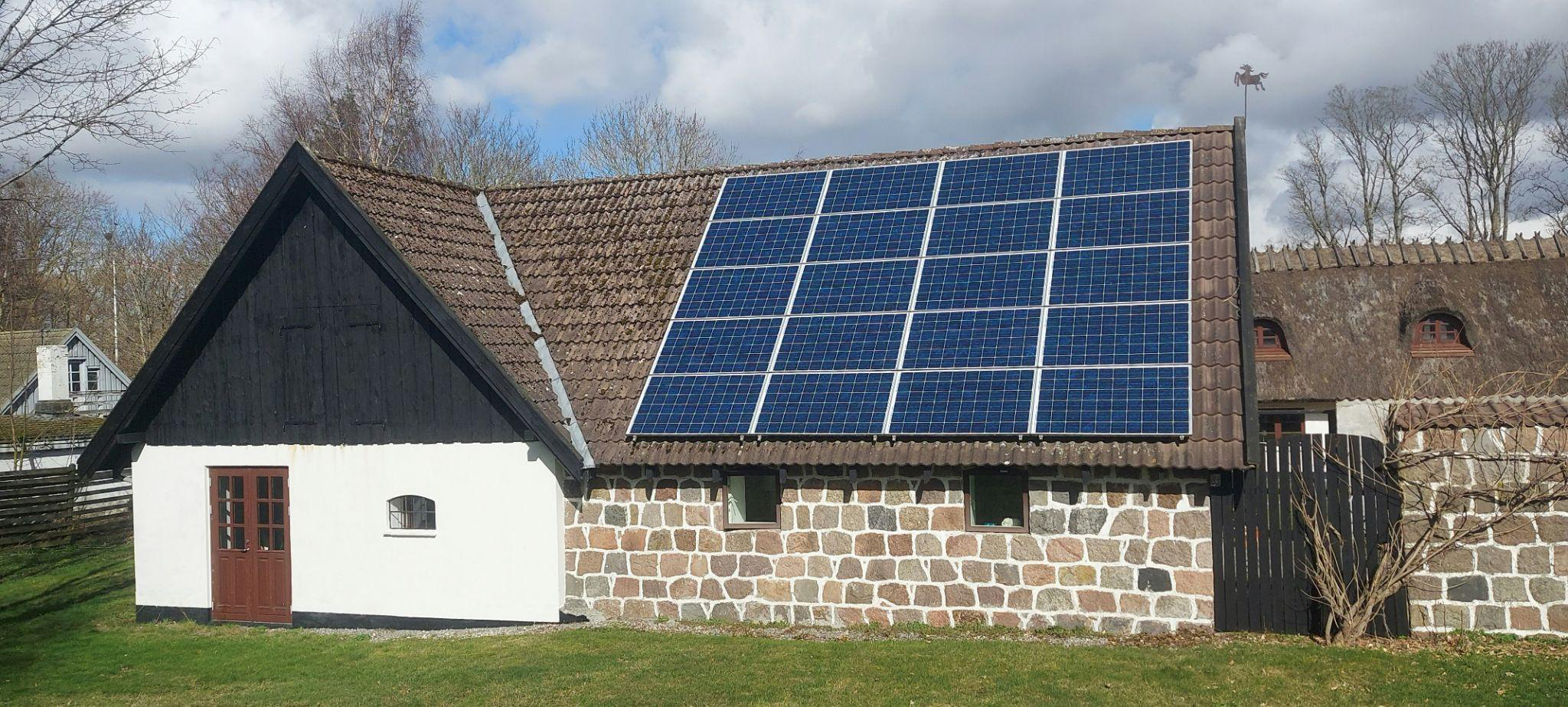 Residential house with roof-mounted solar panels connected to the utility grid
