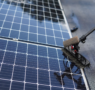 Solar panel cleaning in process using a brush to remove dirt and debris from the surface