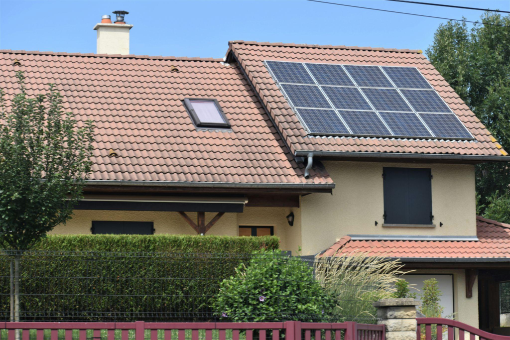 Home with rooftop solar panels installed on a pitched tile roof