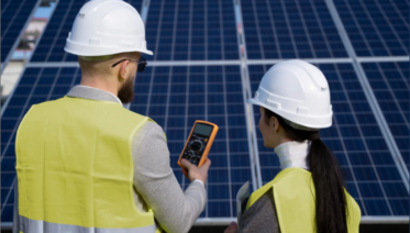 Technicians using an electrical meter to inspect a residential solar system