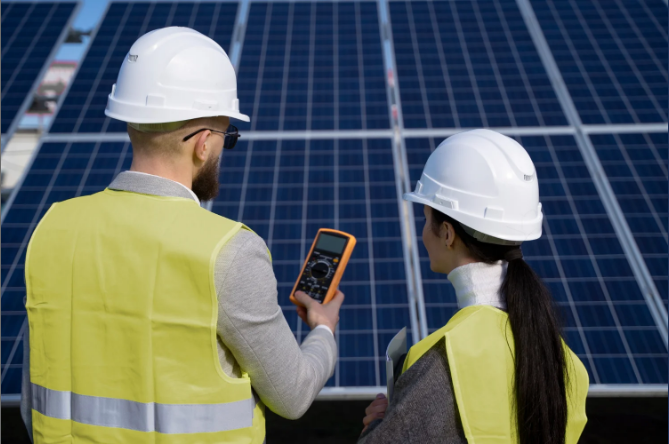 Technicians using an electrical meter to inspect a residential solar system