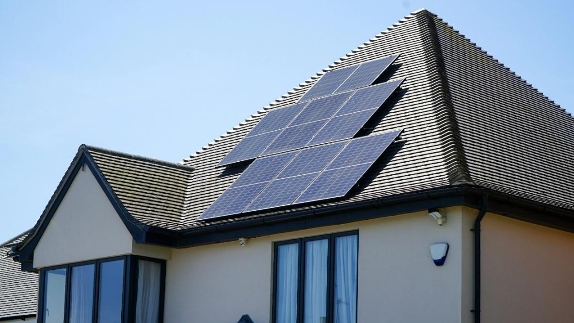 Modern home with rooftop solar panels installed for residential energy generation.