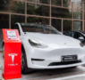White Tesla parked in a residential driveway