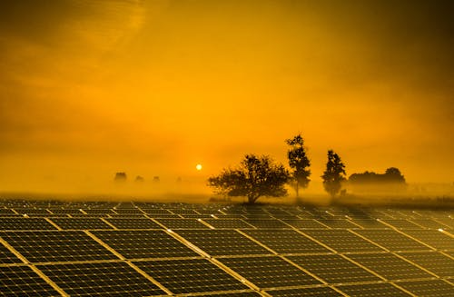 Solar panels installed on a rooftop covered in light fog conditions