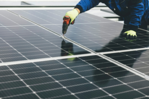 A technician inspecting the mounting brackets of a rooftop solar system