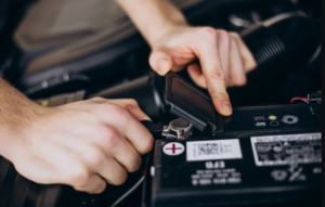 A qualified technician testing the voltage and connections of a residential battery backup system.