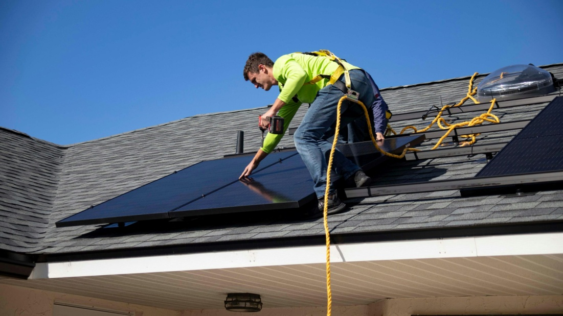 A solar maintenance expert using a specialized soft-wash system