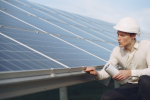 a technician using a thermal imaging device to identify hot spots on a solar panel during inspection