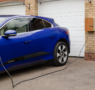 a car plugged into a Level 2 home EV charger in a clean residential garage in the Bay Area
