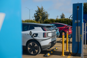 multiple electric vehicles queued at a busy public charging station in San Francisco