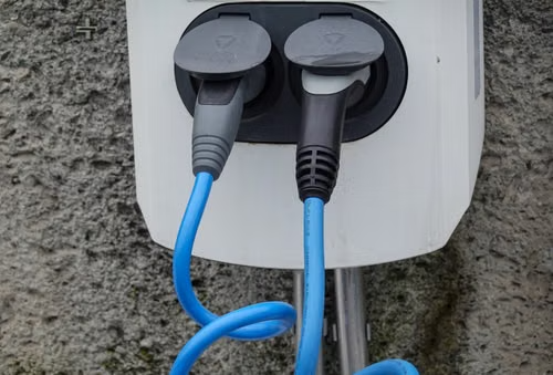 EV charger securely mounted on an exterior residential wall for convenient home charging.