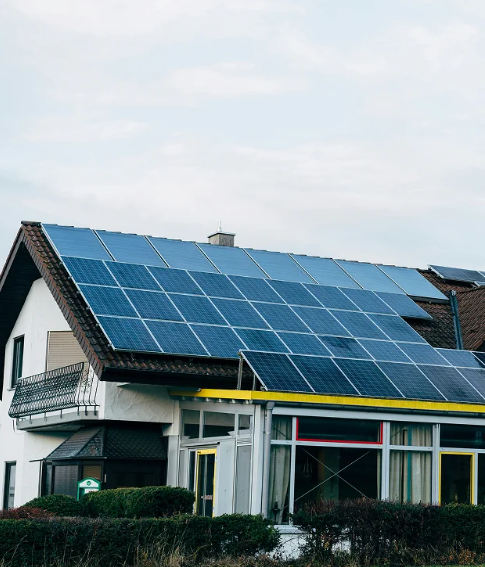 A large house with solar panels on the roof.