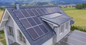 A large house with solar panels all around the roof.